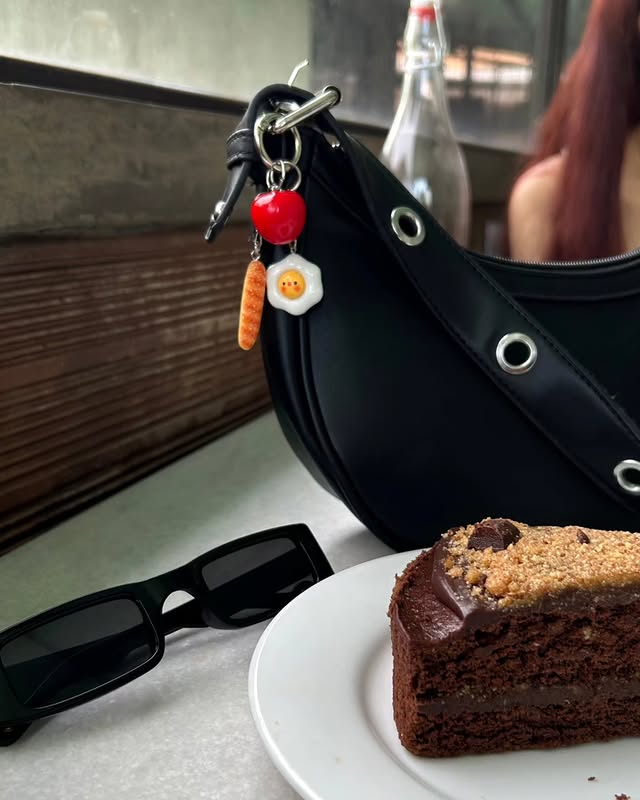 Bag charm styled at a cafe